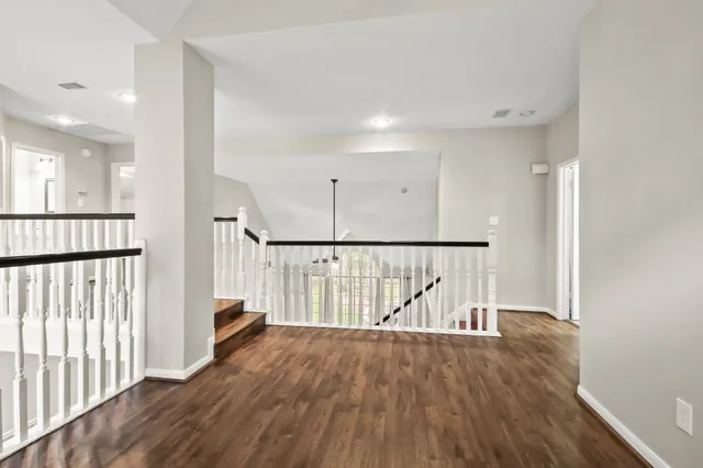 a view of hallway with wooden floor