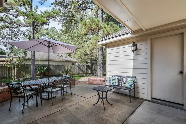 a view of a tables and chairs under an umbrella