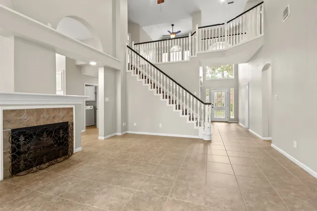 a view of entryway and hall with a fireplace