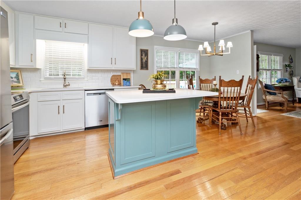 405 Ridgemont Drive Fayetteville, GA 30215 - Photo 13 of 43 a kitchen with a sink dining table and chairs