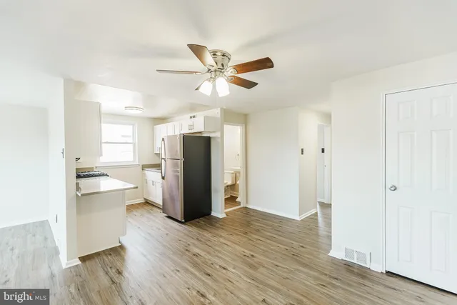a view of a kitchen with a refrigerator and a ceiling fan