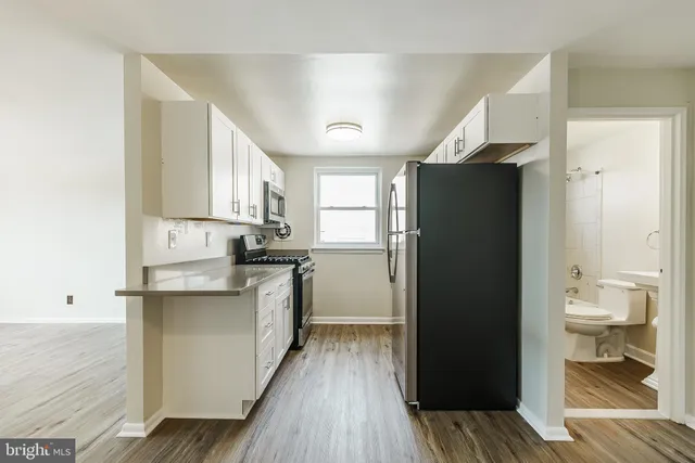 a kitchen with a refrigerator and a sink