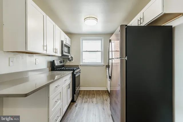 a kitchen with a refrigerator and a stove