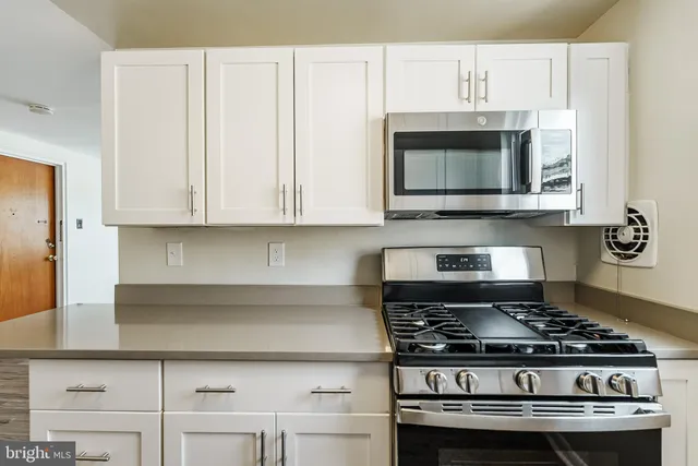 a stove top oven sitting inside of a kitchen