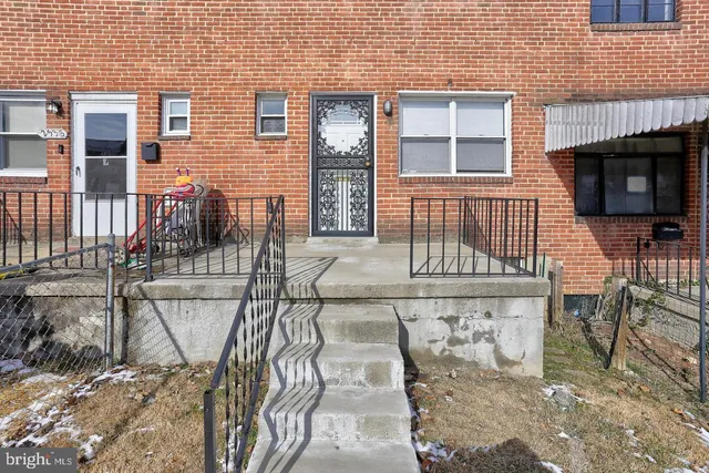 a view of front door of house with outdoor seating