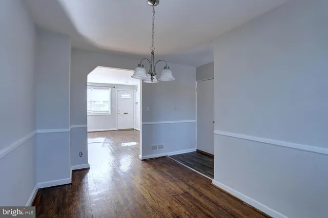 a view of a room with wooden floor and windows