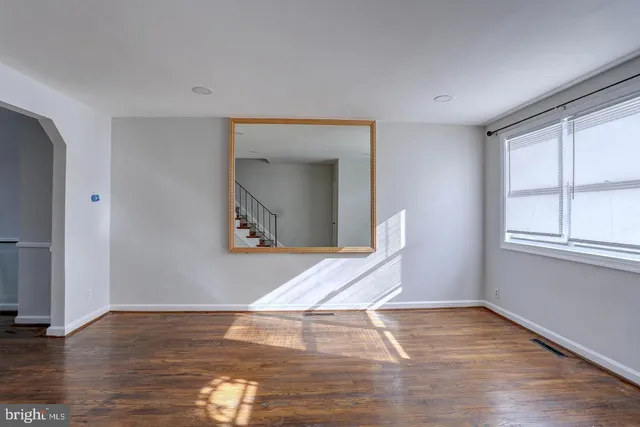 a view of a livingroom with wooden floor and a window