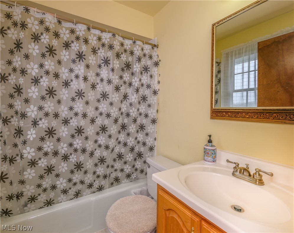 3724 Shellhart Road Barberton, OH 44203 - Photo 29 of 32 Full bathroom with tile floors, vanity, shower / tub combo, and toilet