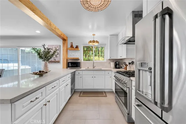 a large kitchen with a sink and cabinets