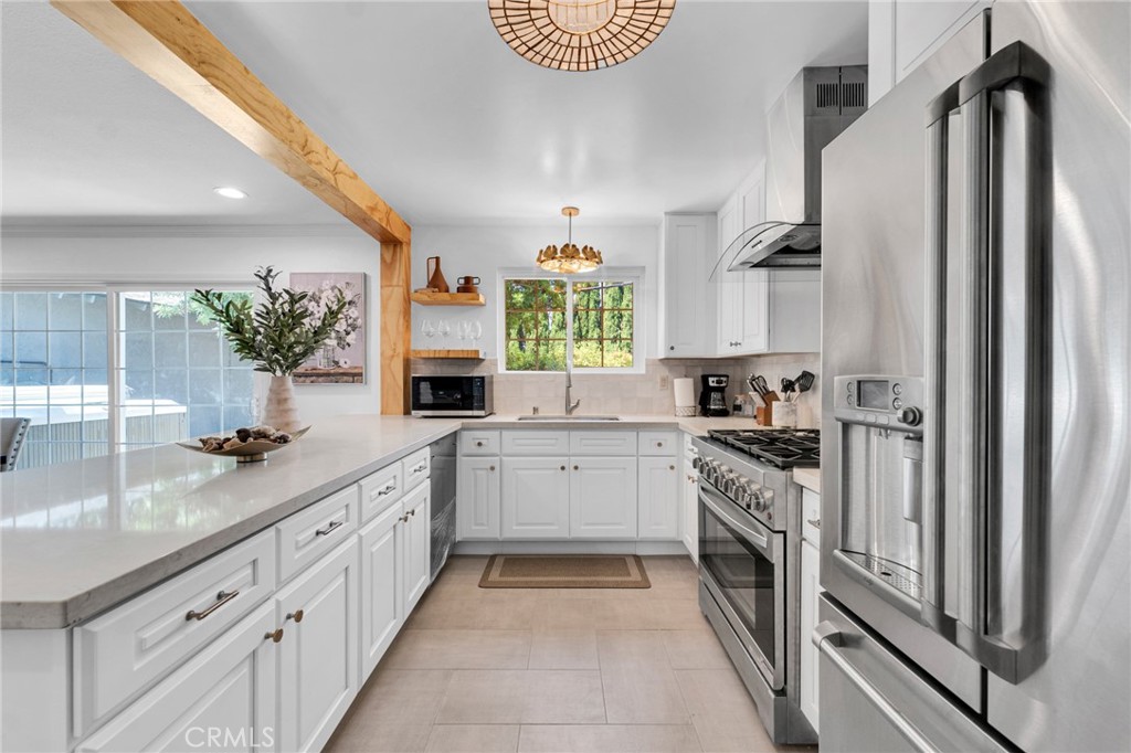 a large kitchen with a sink and cabinets