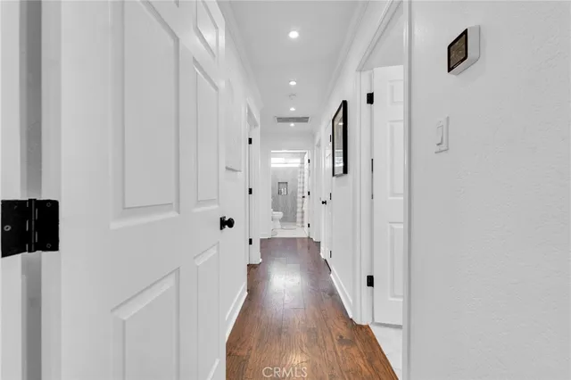 a view of a hallway with wooden floor