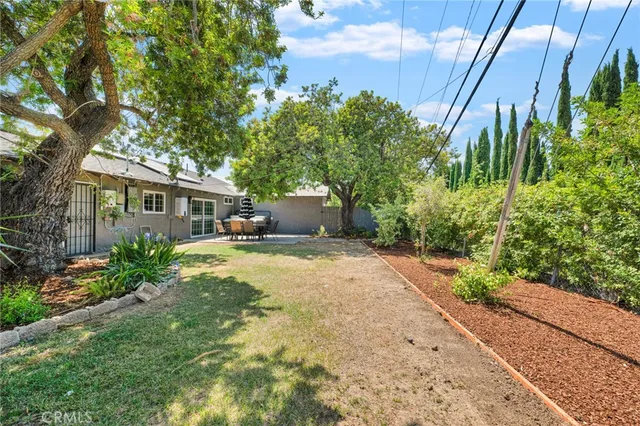 a front view of a house with a yard and a garden