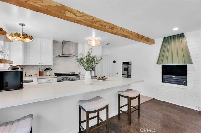 a kitchen with sink a microwave and cabinets