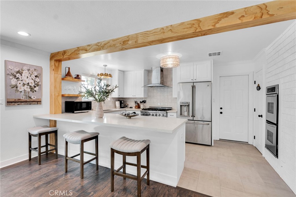 109 Triangle Street Thousand Oaks, CA 91360 - Photo 5 of 32 a kitchen with stainless steel appliances a table and chairs in it