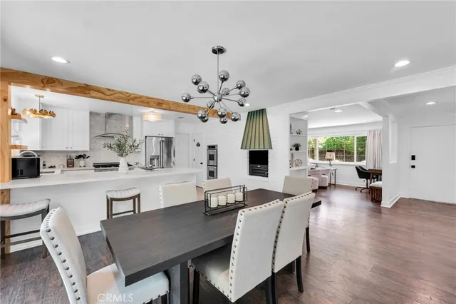 a large kitchen with a table and chairs