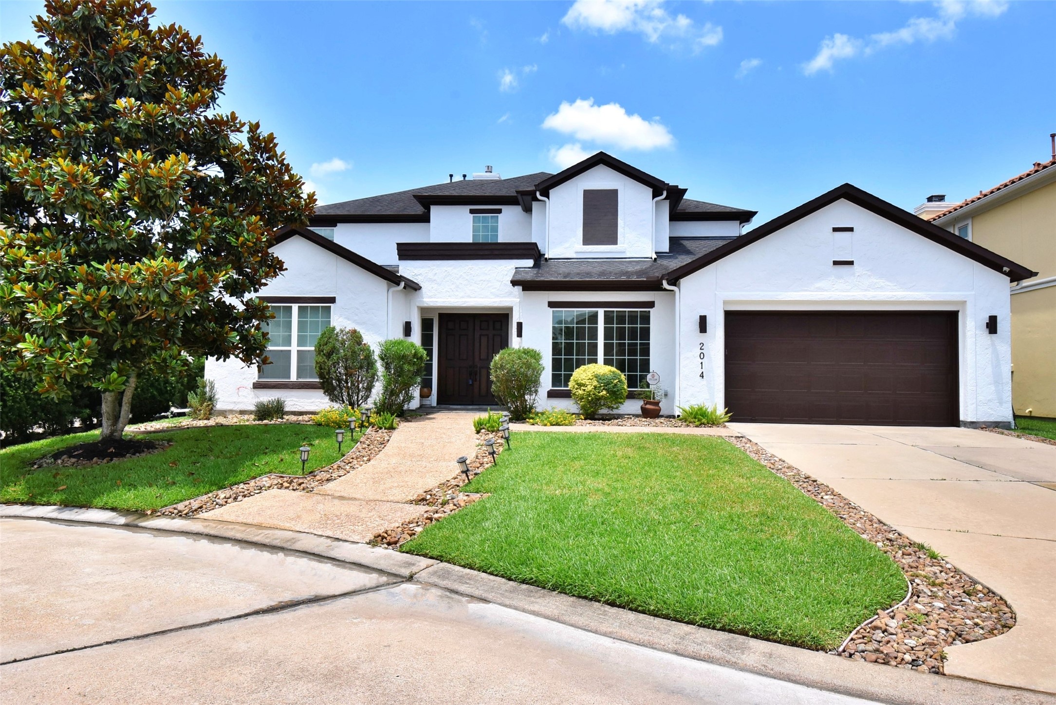 2014 Split Branch Court Houston, TX 77077 - Photo 1 of 47 a front view of a house with a yard and trees