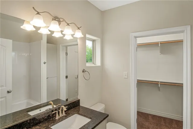 a bathroom with a sink mirror and a shower