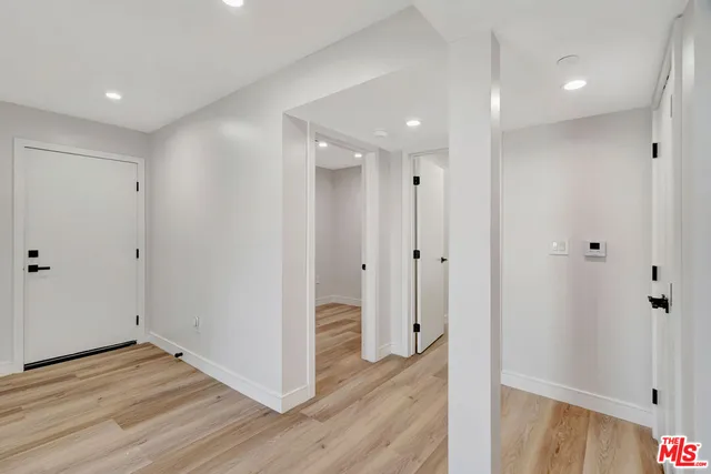 a view of a hallway with wooden floor