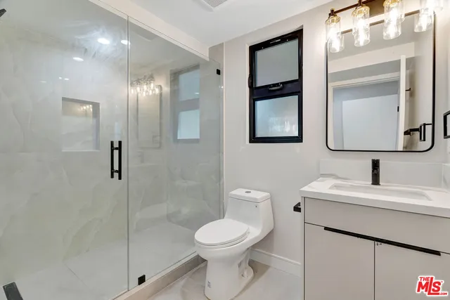 a bathroom with a toilet sink and shower