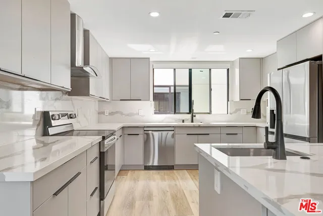 a kitchen with a sink stove and cabinets