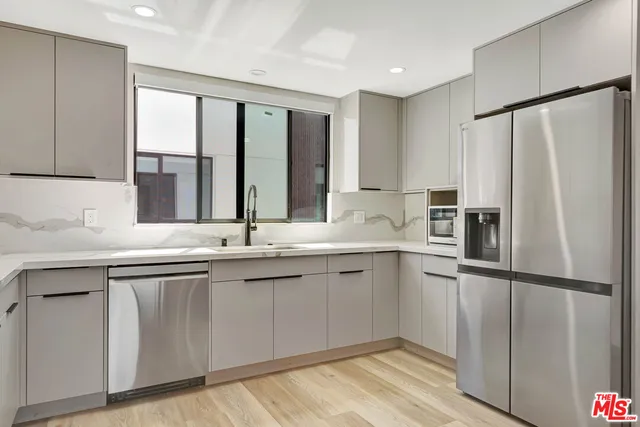 a kitchen with a sink and refrigerator