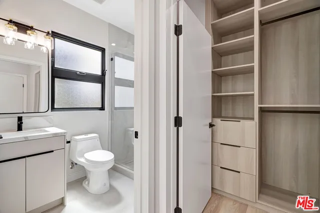 a bathroom with a toilet sink and a mirror