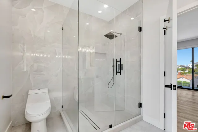 a bathroom with a shower and toilet