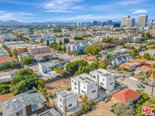 an aerial view of residential houses with city view