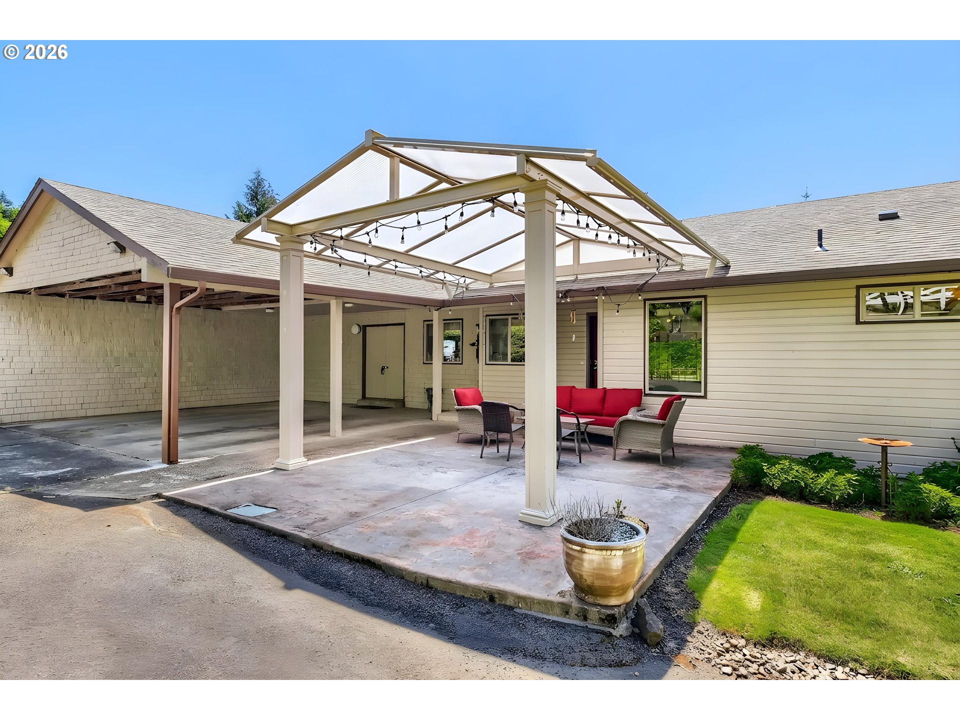 45354 Northwest Hartwick Road Banks, OR 97106 - Photo 32 of 35 a view of a backyard with table and chairs under an umbrella