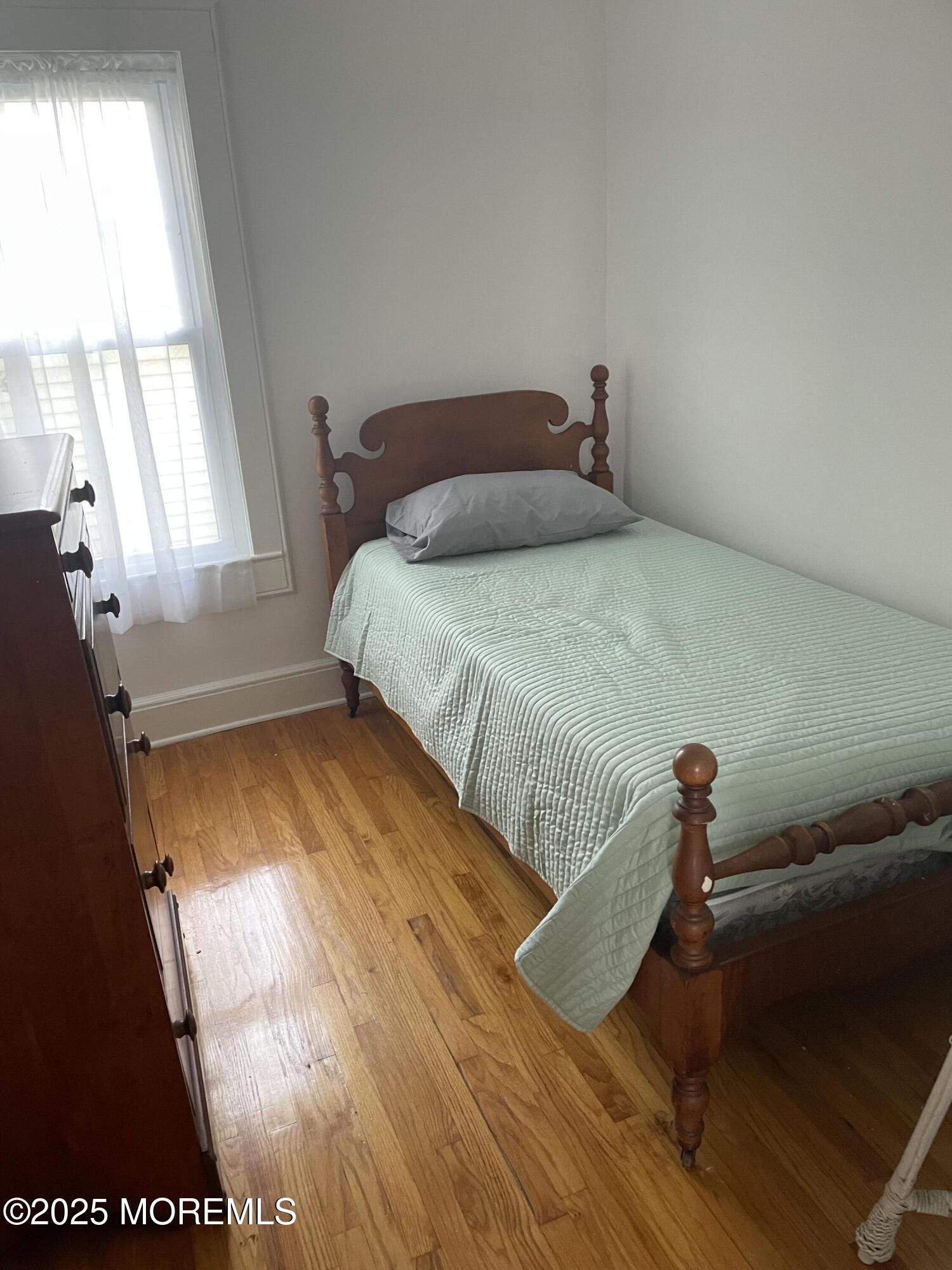 411 Fifth Avenue Avon-by-the-Sea, NJ 07717 - Photo 4 of 5 a bedroom with a bed and window
