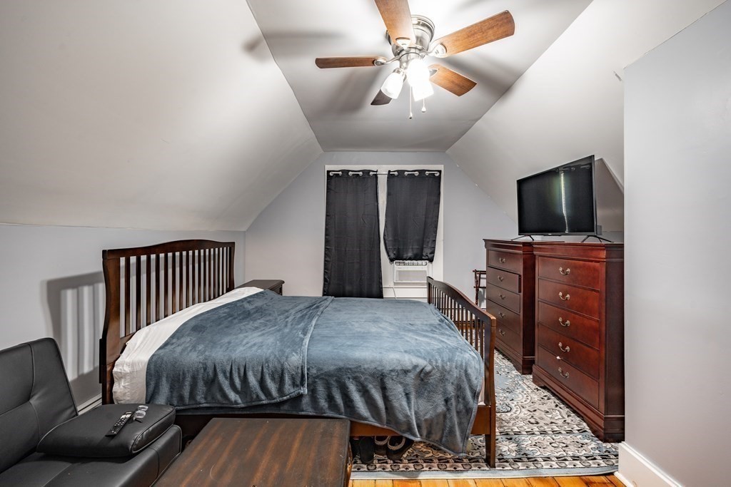 175 Mill Street Springfield, MA 01108 - Photo 16 of 42 a bedroom with a bed and a flat screen tv