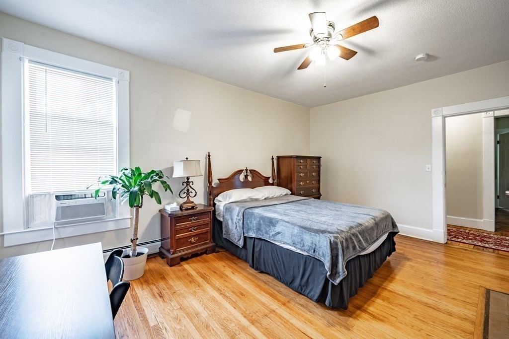 175 Mill Street Springfield, MA 01108 - Photo 19 of 42 a bedroom with bed and a potted plant