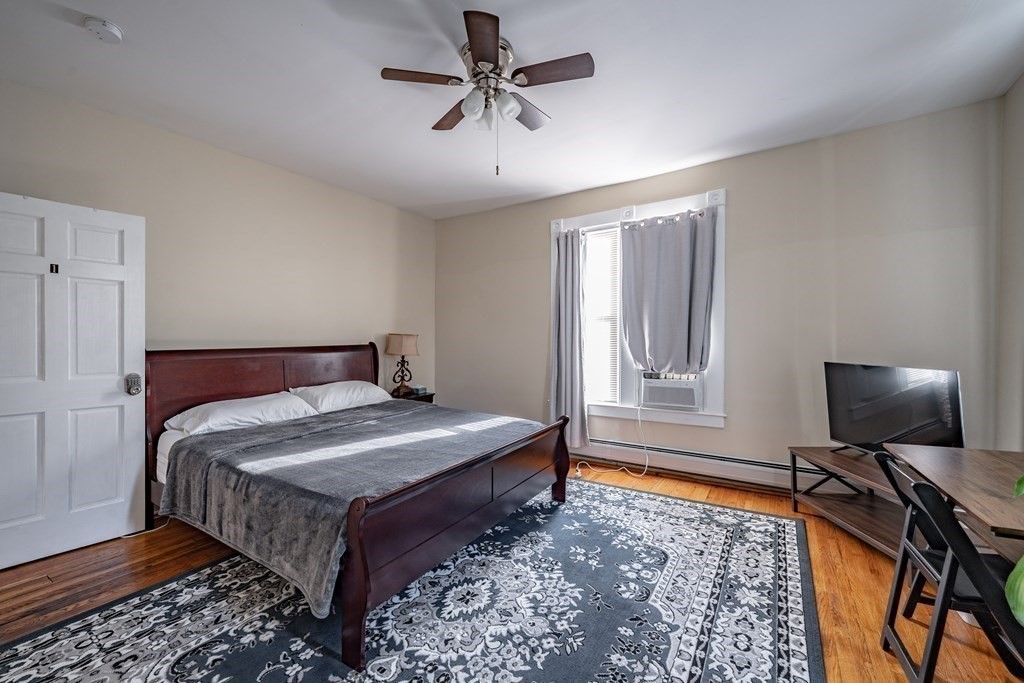 175 Mill Street Springfield, MA 01108 - Photo 22 of 42 a bedroom with a bed and a flat screen tv