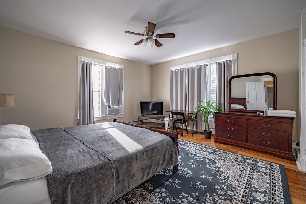 175 Mill Street Springfield, MA 01108 - Photo 23 of 42 a bedroom with a bed and a dresser