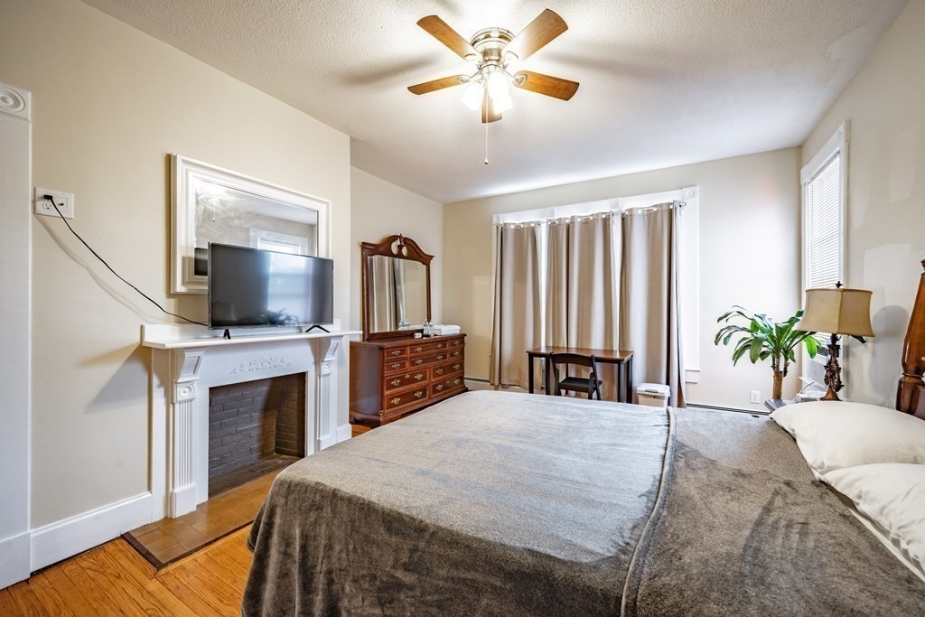 175 Mill Street Springfield, MA 01108 - Photo 27 of 42 a spacious bedroom with a bed and a flat screen tv