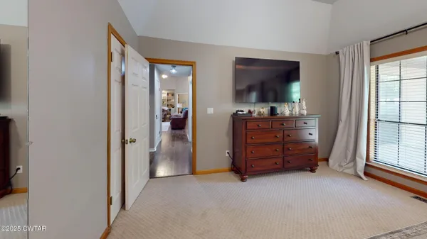 an empty room with furniture and a flat screen tv