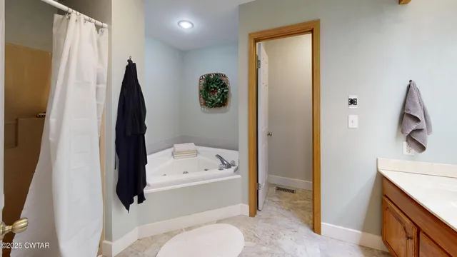 a bathroom with a tub sink and toilet