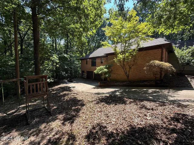 a backyard of a house with lots of green space