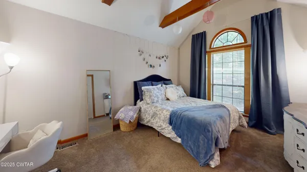 a bedroom with a bed and a window