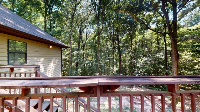a view of a wooden deck and a yard