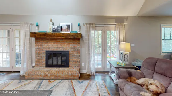 a living room with furniture and a fireplace