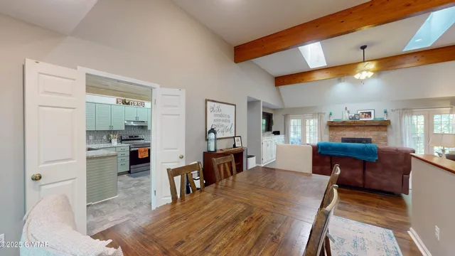 a living room with furniture a dining table and chairs with wooden floor