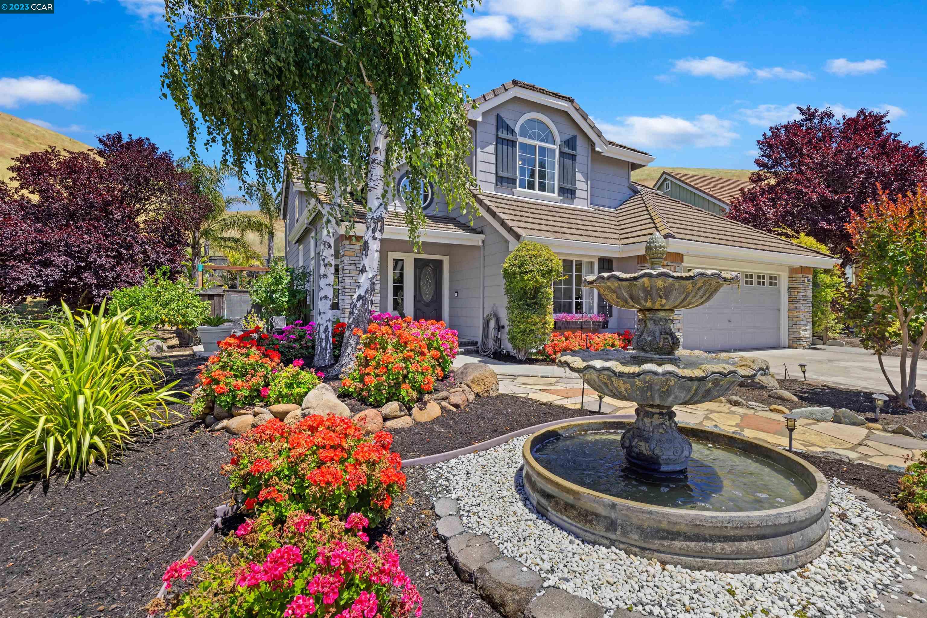 3083 Windmill Canyon Drive Clayton, CA 94517 - Photo 1 of 1 a front view of house and yard with green space