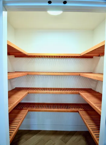 a kitchen with stainless steel appliances white cabinets and a refrigerator