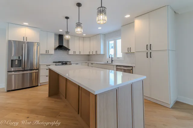 a stove top oven sitting inside of a kitchen