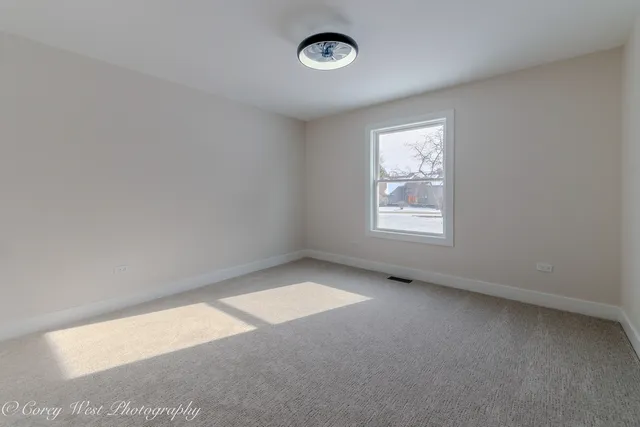 an empty room with closet and a bathroom