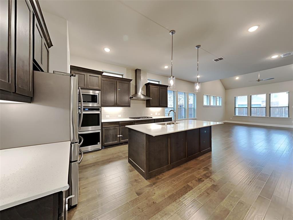 8262 Ottowa Ridge Frisco, TX 75034 - Photo 5 of 24 a large kitchen with stainless steel appliances granite countertop a large counter top and a stove