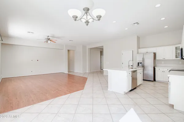 a living room with furniture kitchen view and a flat screen tv