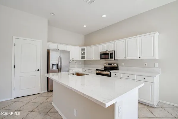 a view of kitchen with furniture and ceiling fan