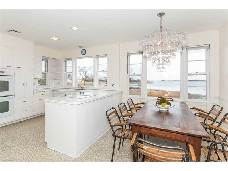 5 Bridle Path Lane Riverside, CT 06878 - Photo 8 of 11 a kitchen with a table chairs stove and cabinets